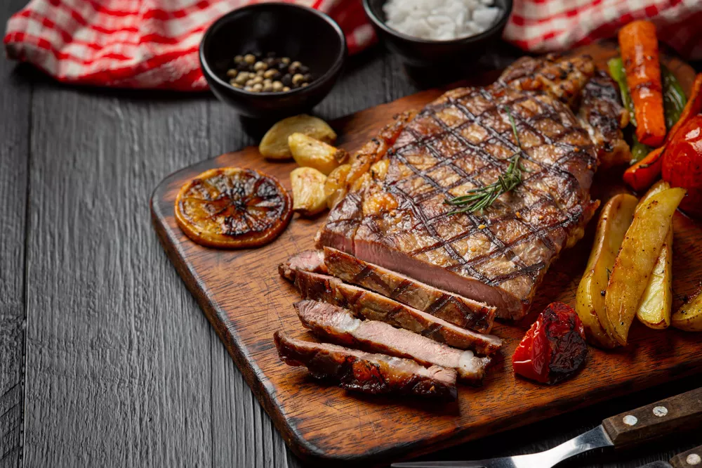 grilled-beef-steak-on-the-dark-wooden-surface
